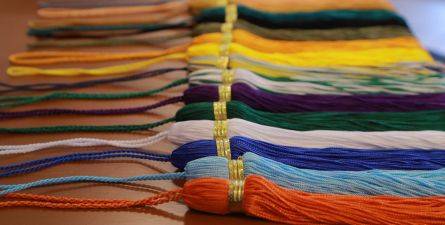 Tassels of varying colors side by side on table