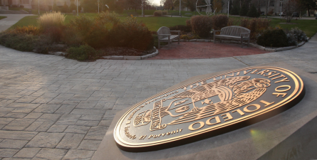 Sun shining on university seal