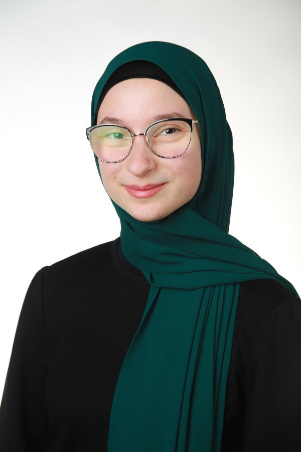 Yasmeen Hamdah Headshot of Yasmeen Hamdah; woman in dark green hijab and black glasses