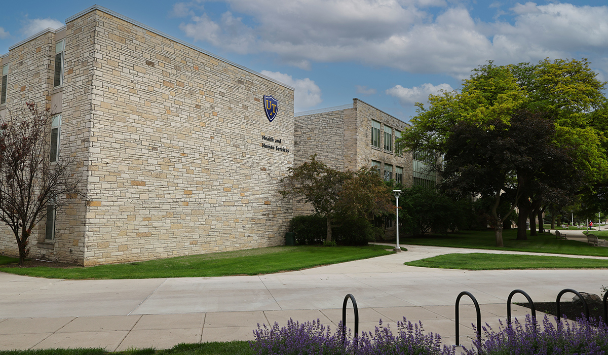 the outside of the health and human services building on a sunny day