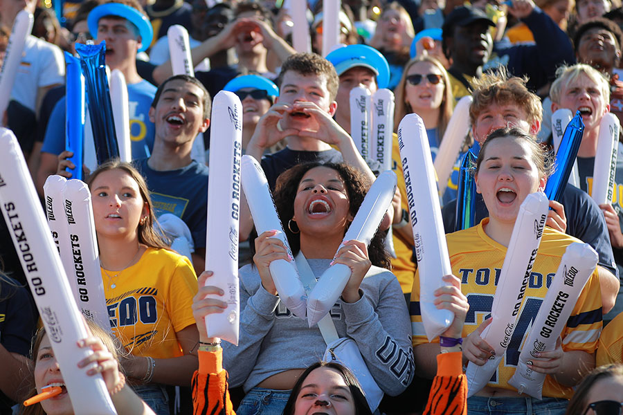 crowd cheering in the homecoming football game student section