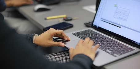 Image close up of hands typing on a latop computer