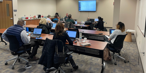 A group of entrepreneurs sitting in a classroom setting learning how to buildtheir business ideas 