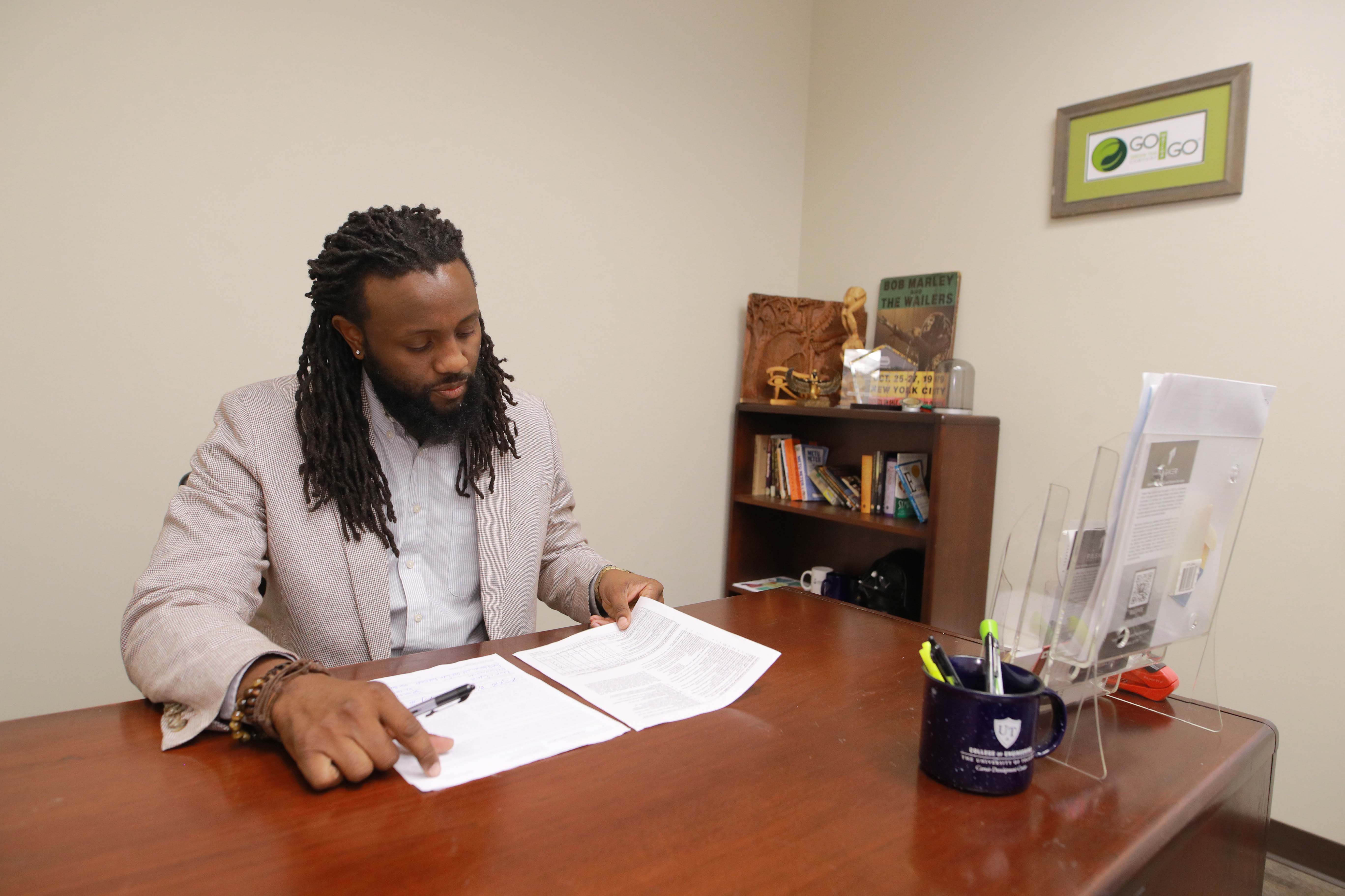 Man at a desk looking over paperwork