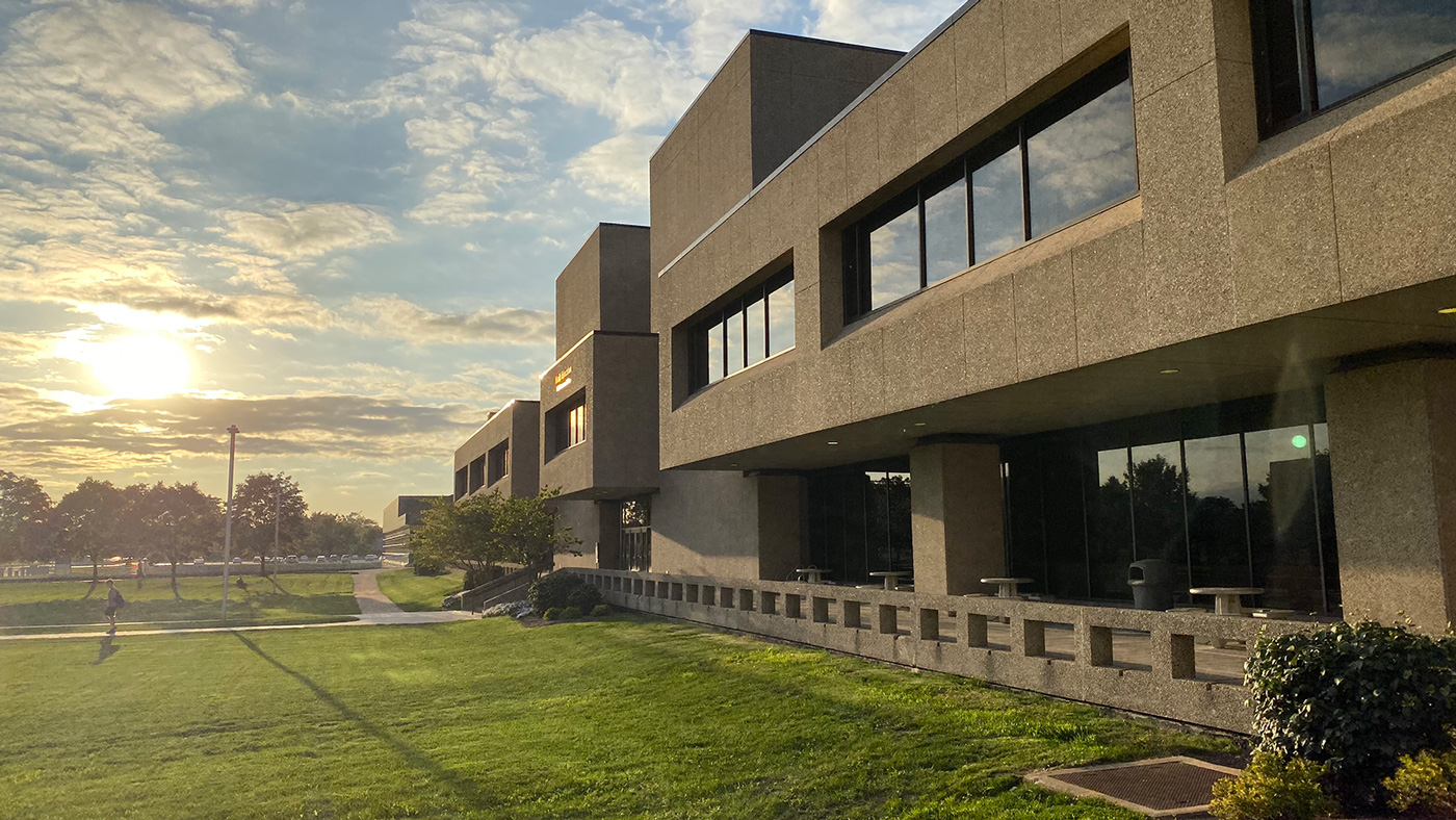 The sun sets on Health Science Campus, with the Health Education Building on the right.