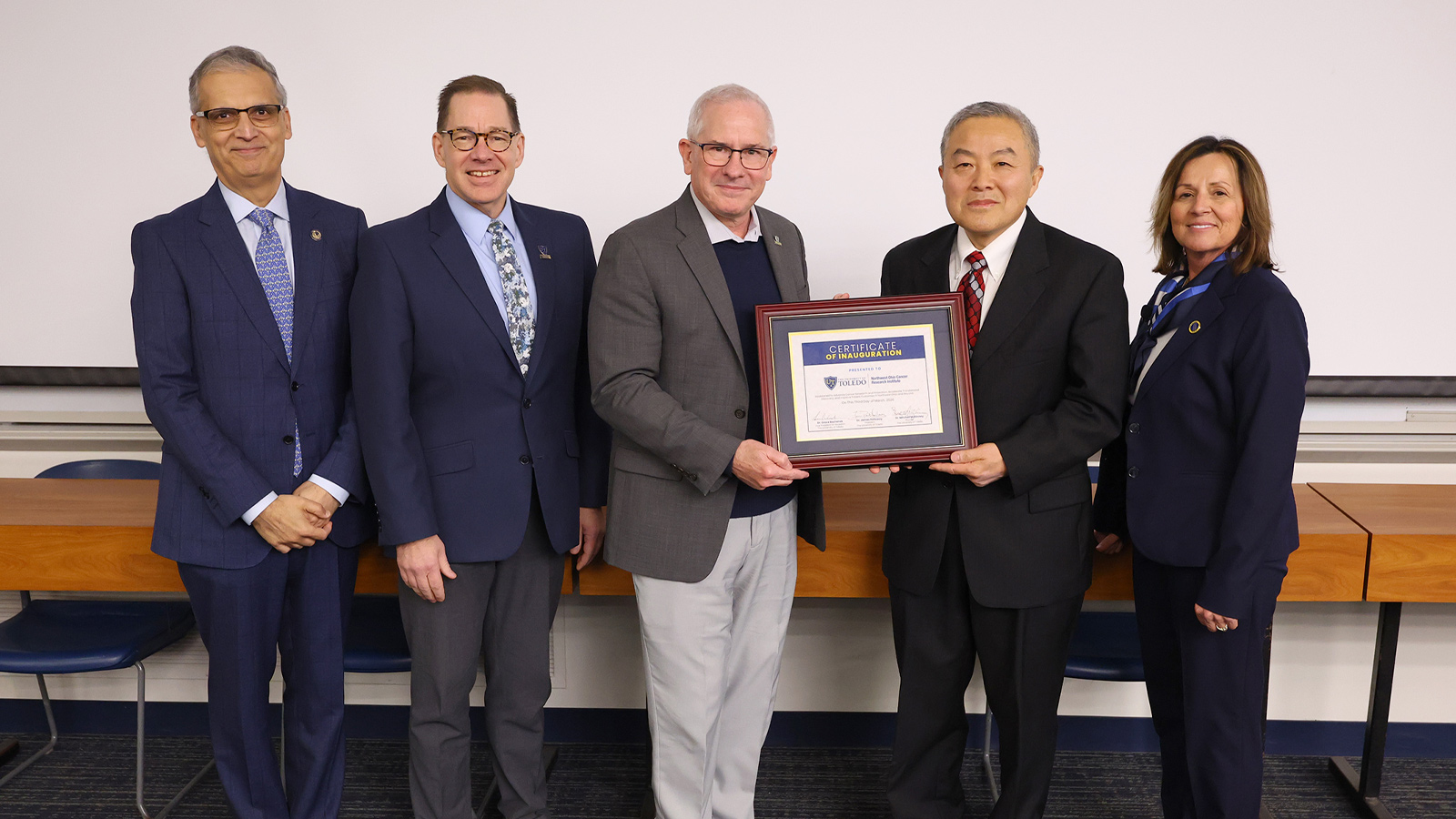 University leaders and institute representatives pose with a certificate marking the inauguration of the Northwest Ohio Cancer Research Institute at The University of Toledo.