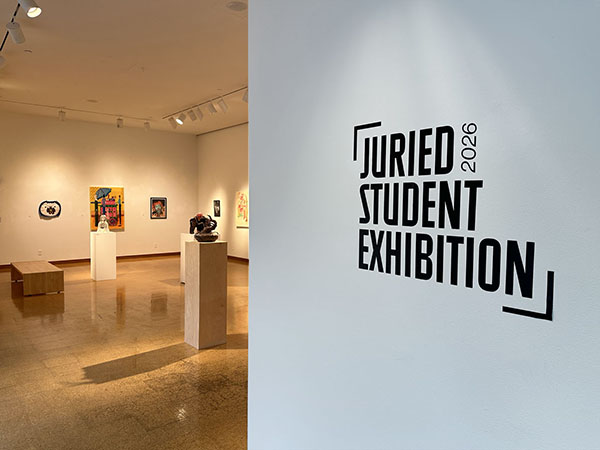 Artwork on display at the Center for the Visual Arts, the wall in the gallery room has text on it that states "2026 Juried Student Exhibition"