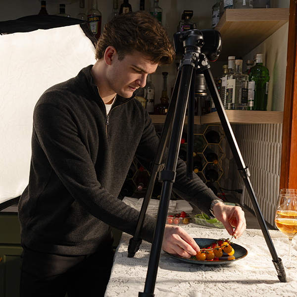 Alumni Vince Livecchi setting up a plate for food for a photo shoot