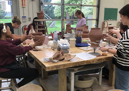 sculpture students working in classroom