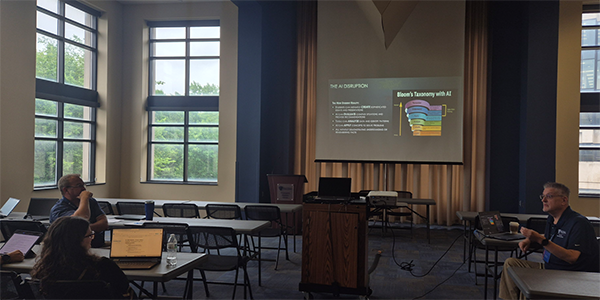 students in a classroom look at a presentation on a projecter screen