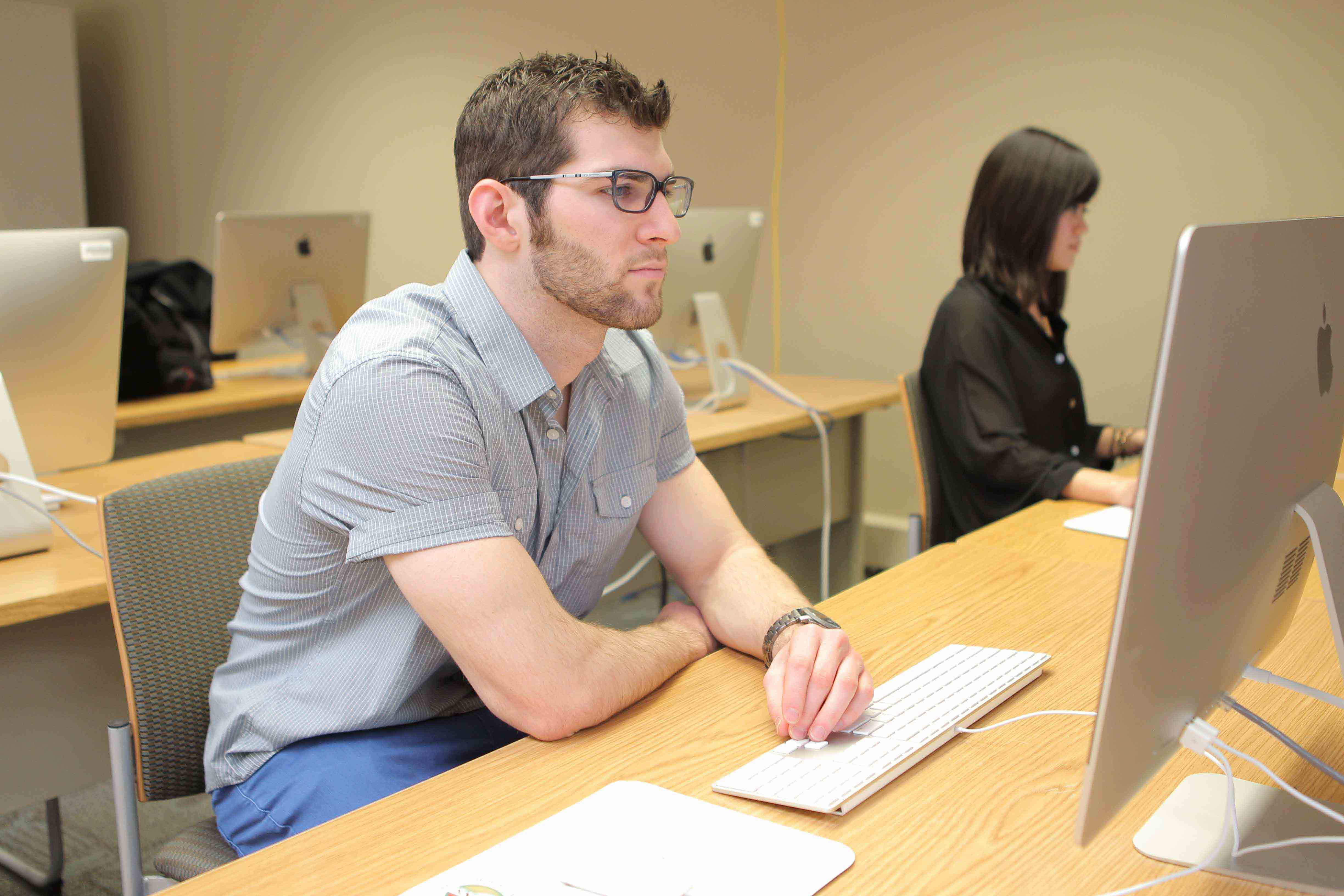 Student working at one of the MAC computers