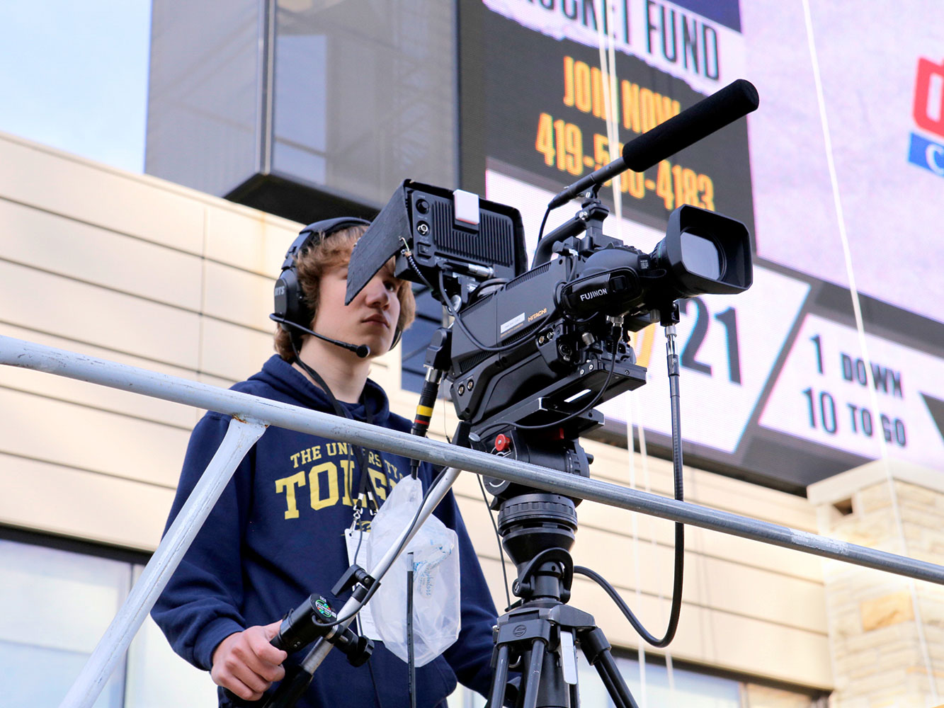 student filming for espn at UToledo football game