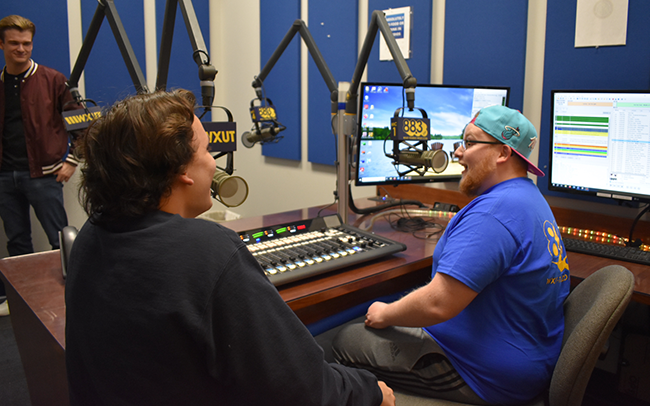two students in the WXUT studio 