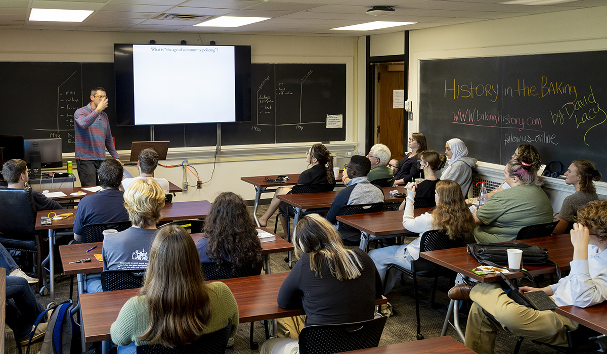 Associate Professor Michael Stauch giving a lecture to a classroom full of history students