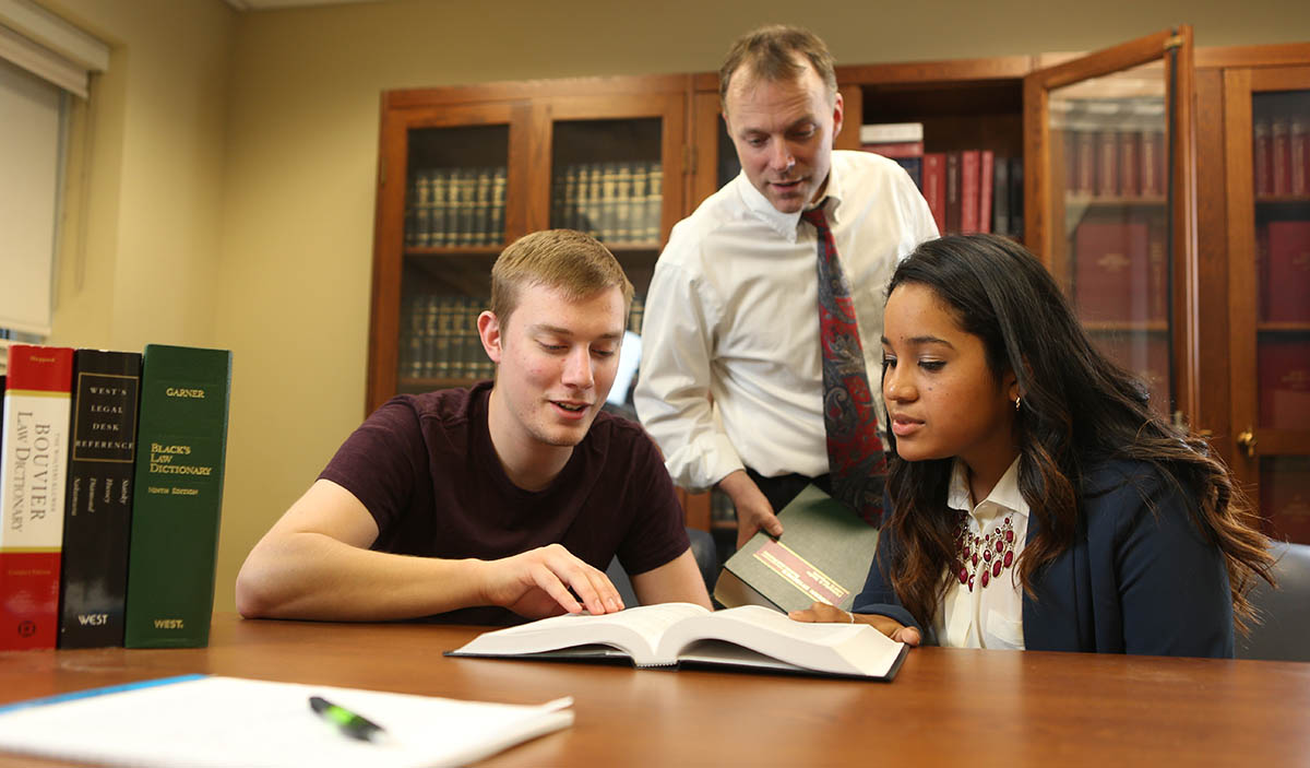 John Schlageter in mock trial room with two students