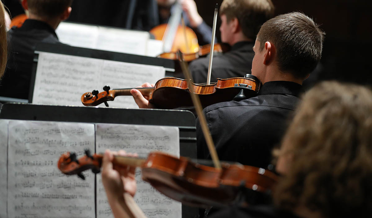 violinist playing in orchestra