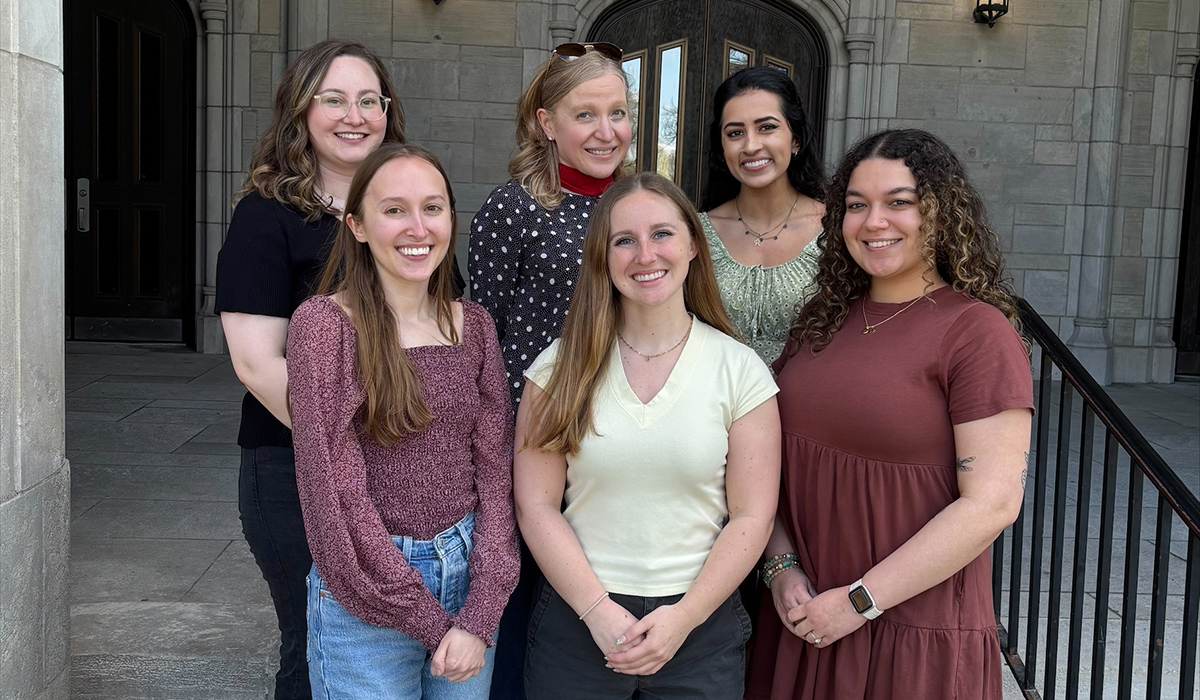 six women standing in front of university hall taking a group photo for the Child Anxiety and Stress Lab