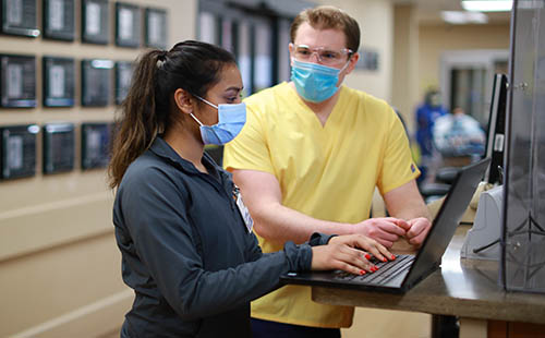 two hospital employees talking