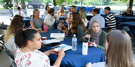 students outdoors at table eating ice cream