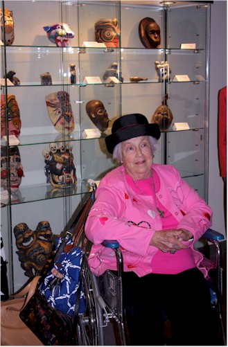Dorothy Price in front of her mask collection