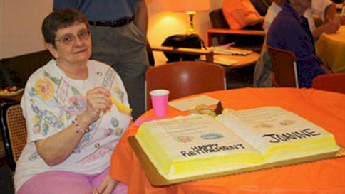 Joanne Hartough enjoys cake at her retirement party