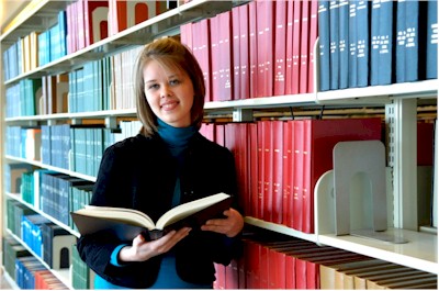 Student researching in journal stacks