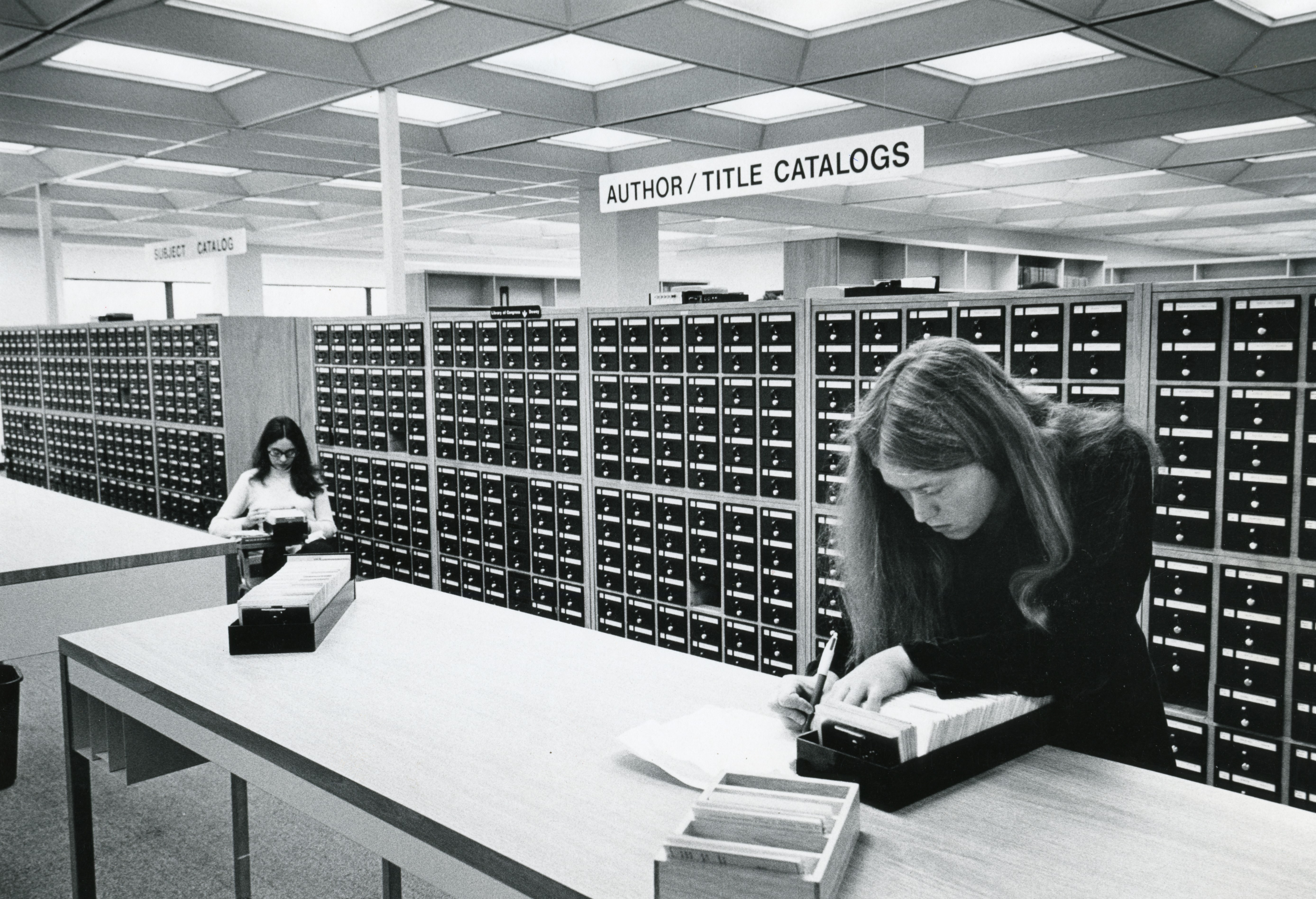 Students using the library index cards for research