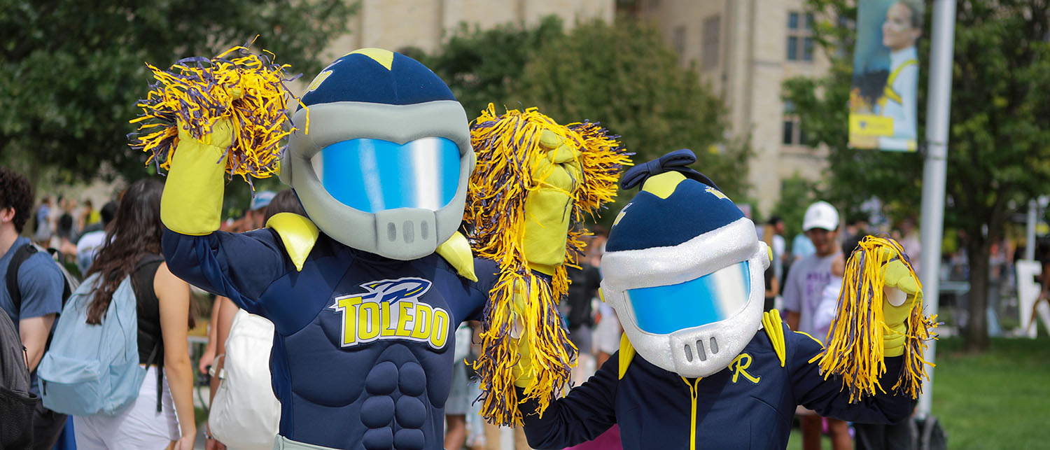 Rocky and Rocksy holding pom poms at a campus event