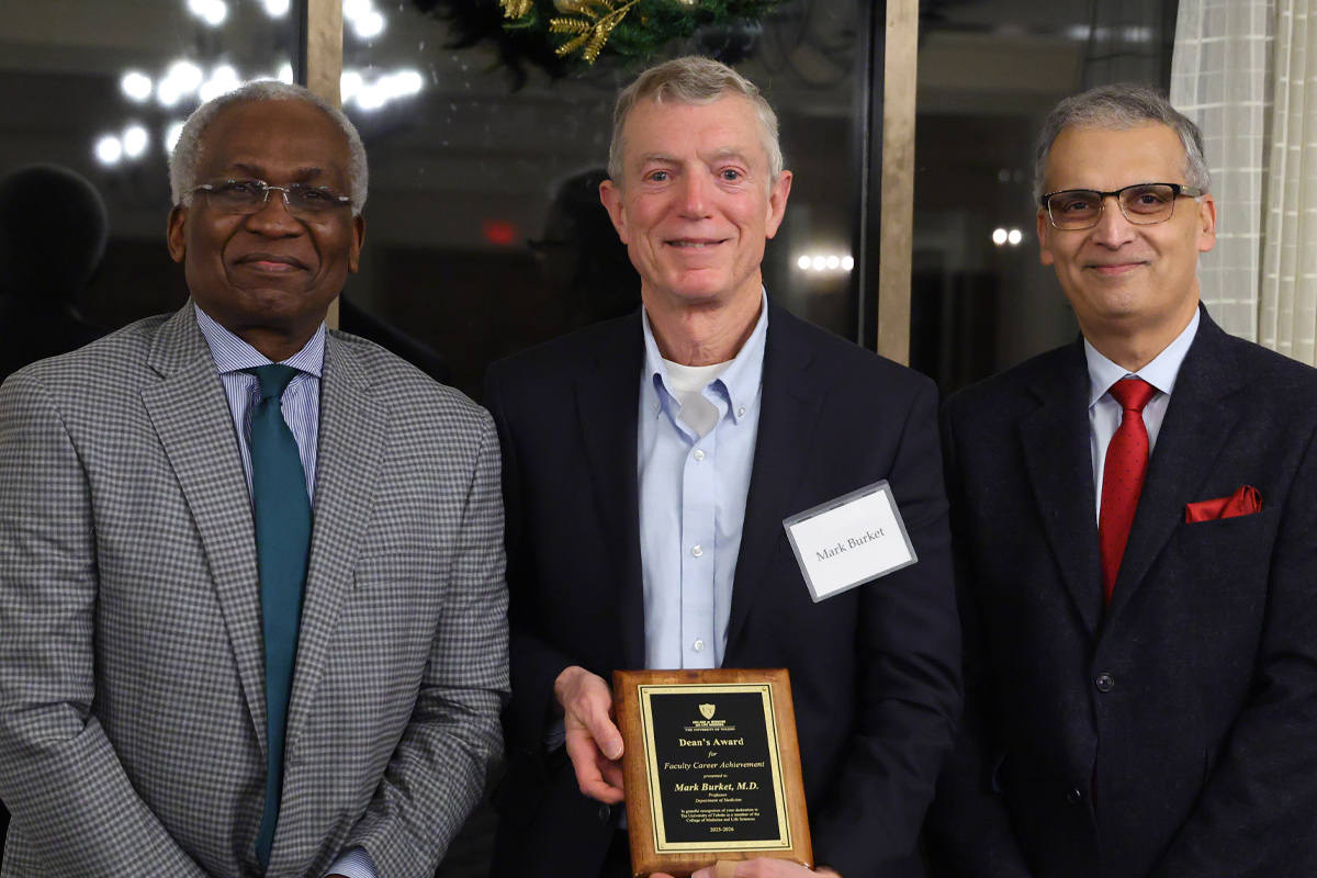 Dr. Mark Burket accepts his award for Faculty Career Achievement and poses for a photo with Dr. Basil Akpunonu and Dean Imran Ali and at the Faculty and Staff Recognition Awards dinner.