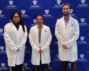 Photo of three students entering BMSP Cell & Cancer Biology track