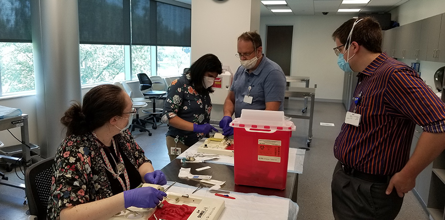 Photo of residents working with faculty