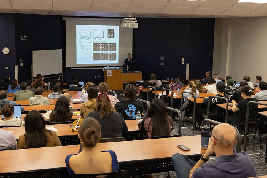 Audience listens as Dr. Jiaoti Huang presents research findings during the Graduate Research Annual Forum keynote session.