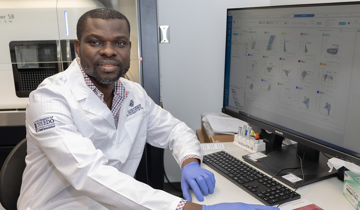  Olalekan Olatunji is pictured sitting at a computer in a lab and conducting his research.