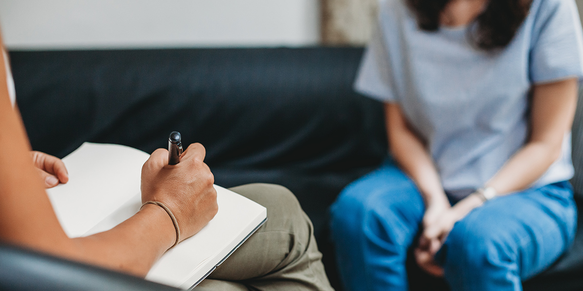 Stock photo of a Psychotherapy session, woman talking to his psychologist in the studio