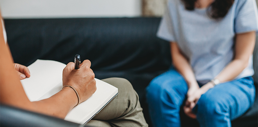 Stock photo of a Psychotherapy session, woman talking to his psychologist in the studio
