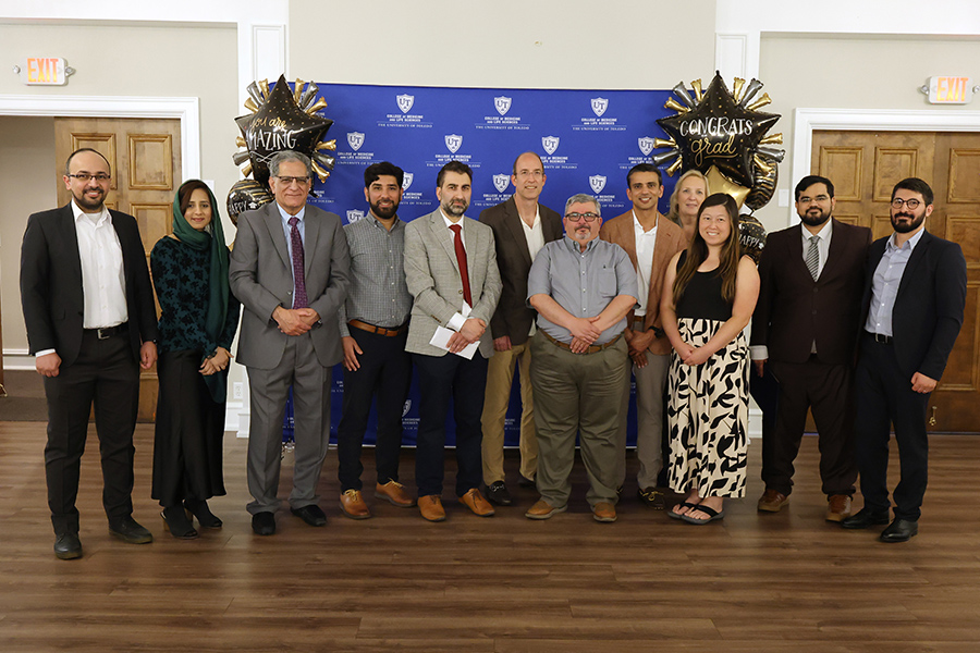 Faculty with fellows at graduation