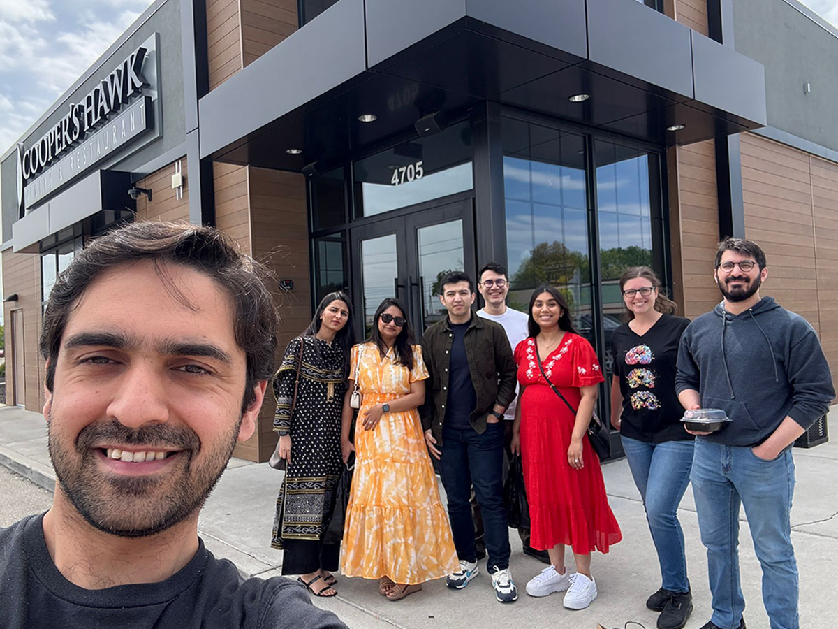 Residents in a group photo outside of a restaurant