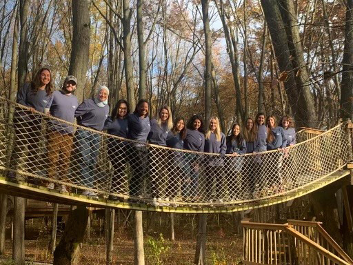 Group photos of residents on retreat at the tree house village, on a rope bridge.
