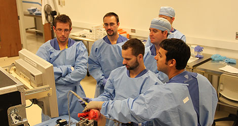 residents looking at a monitor in the lab