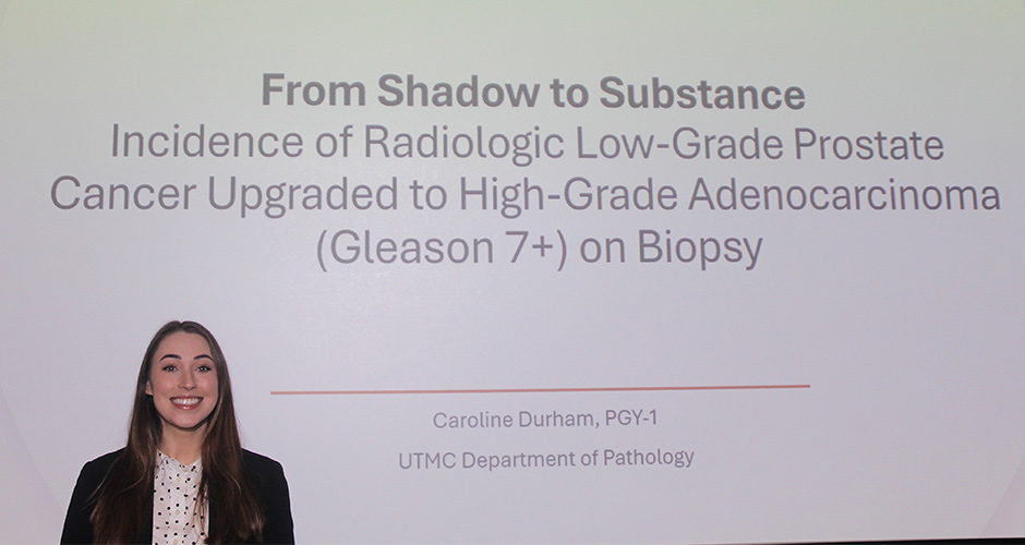 Resident at a conference in front of her presentation
