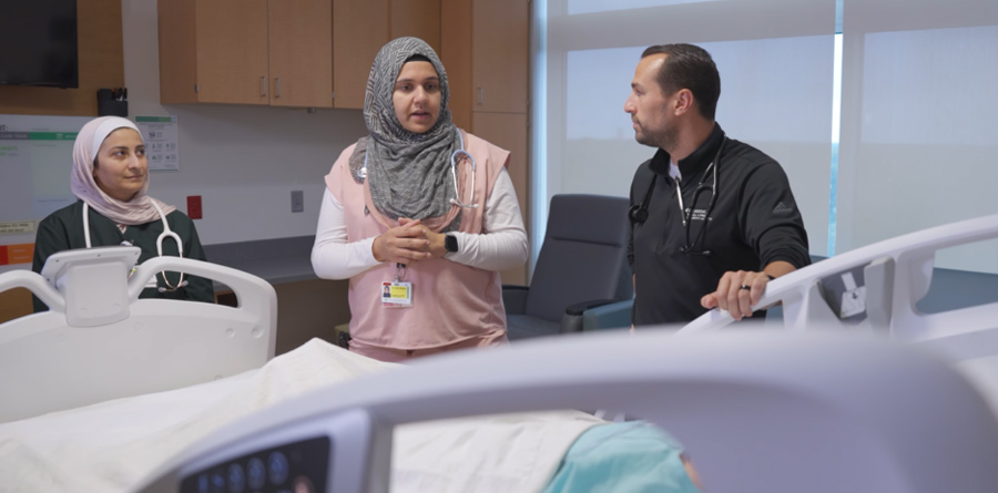 Three members of the department inside a patient room