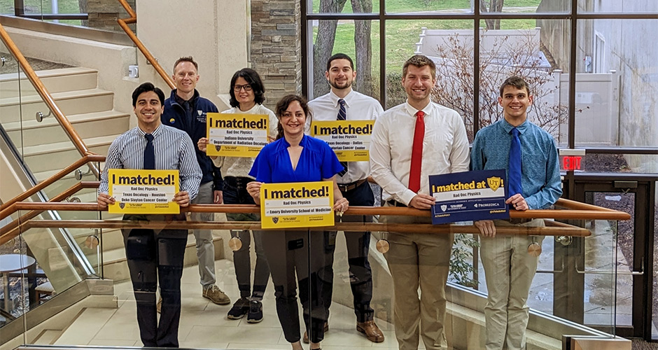 A group of residents pictured in the lobby holding match signs