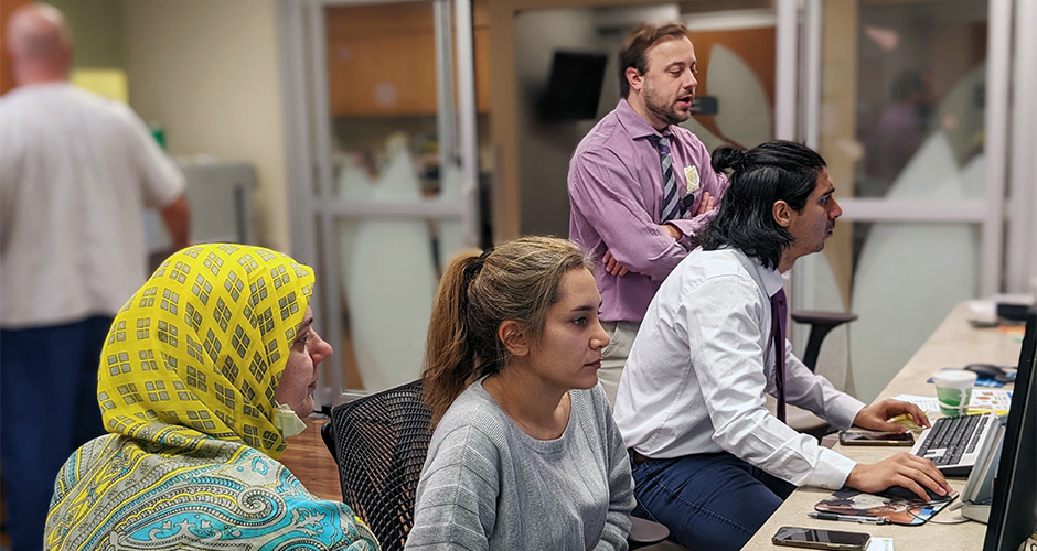 A group of residents pictured working in an office