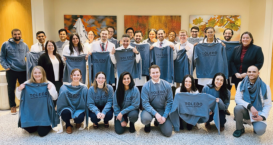 Surgery residents showcase their new sweatshirts in a group photo