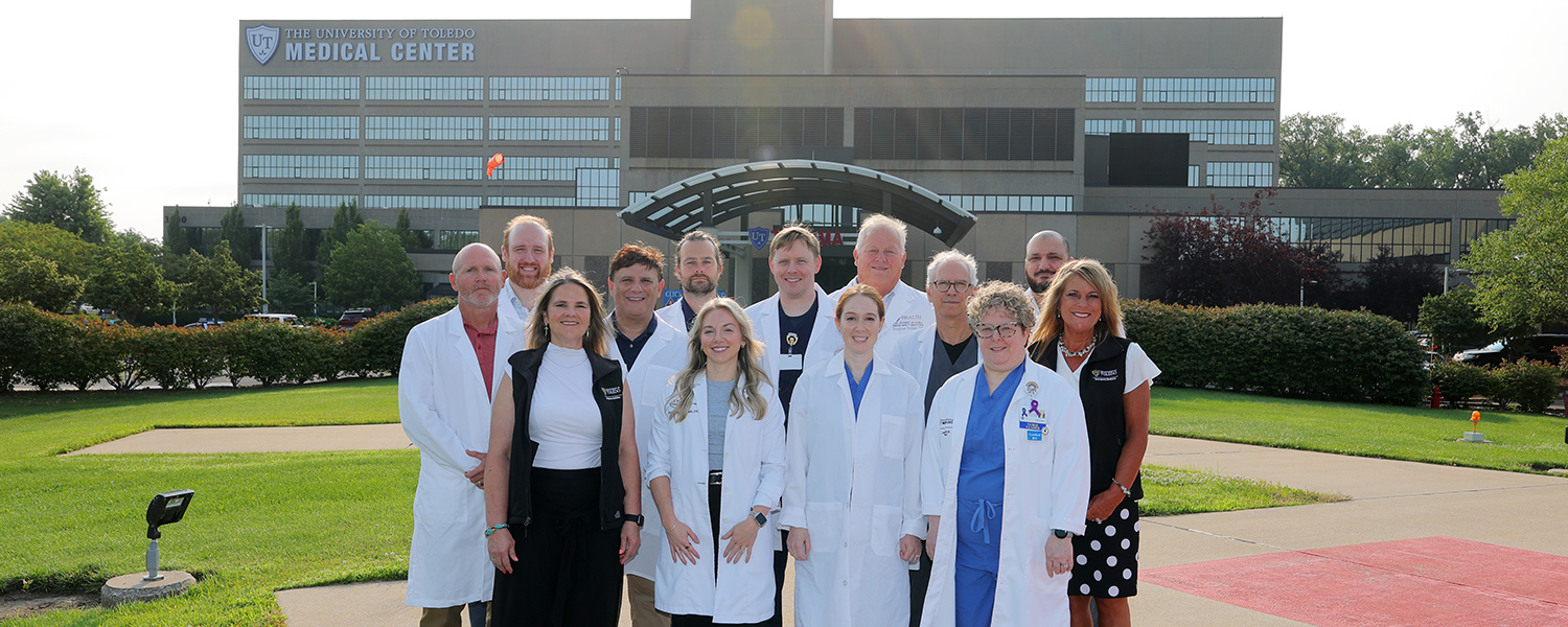 A group photo of emergency medicine faculty taken outside of the UTMC hospital
