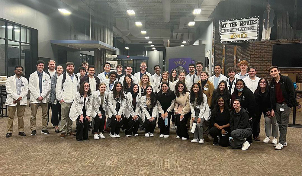 A group of students and volunteers pose for a photo at a recent CommunityCare Clinic. 