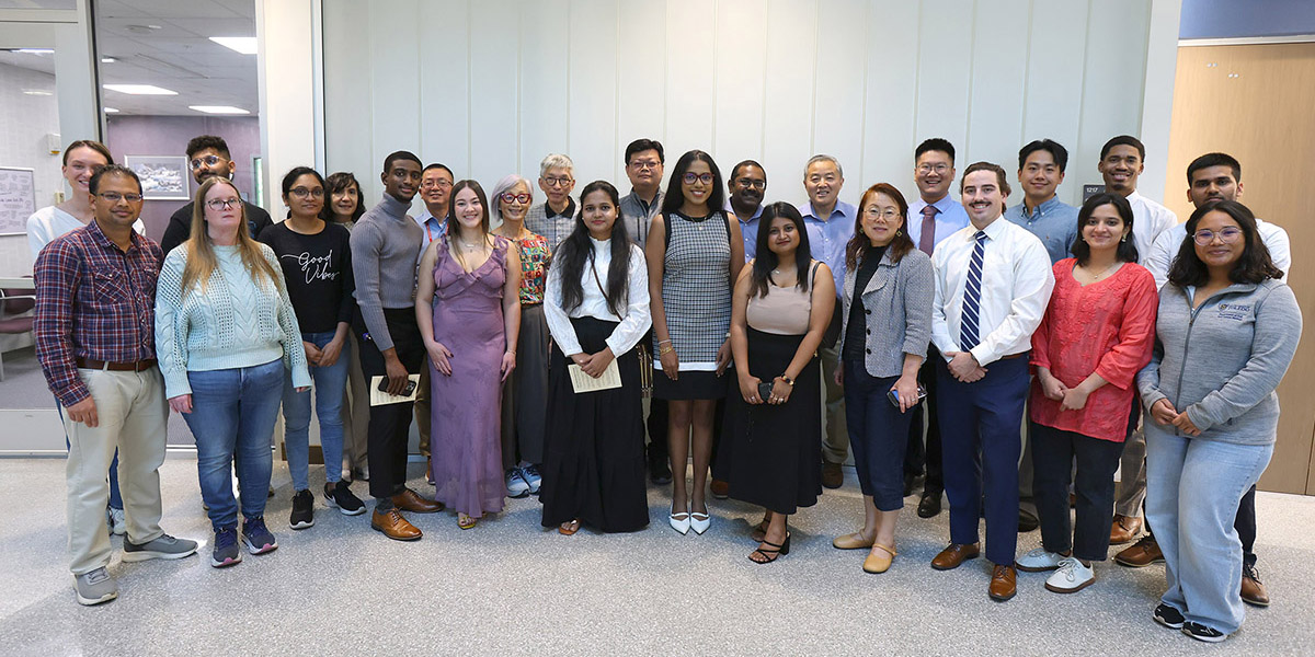 Attendees pose for a group photo inside the Simulation Center atrium after the ceremony.