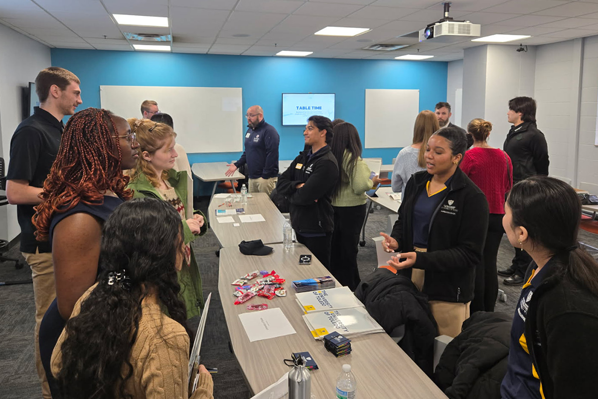 Students are pictured at a mentorship event at the University of Dayton, speaking to pre-med students. 