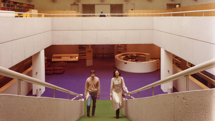 A photo from the grand opening of the Mulford Library 50 years ago with 2 people walking up the top of the stairs.