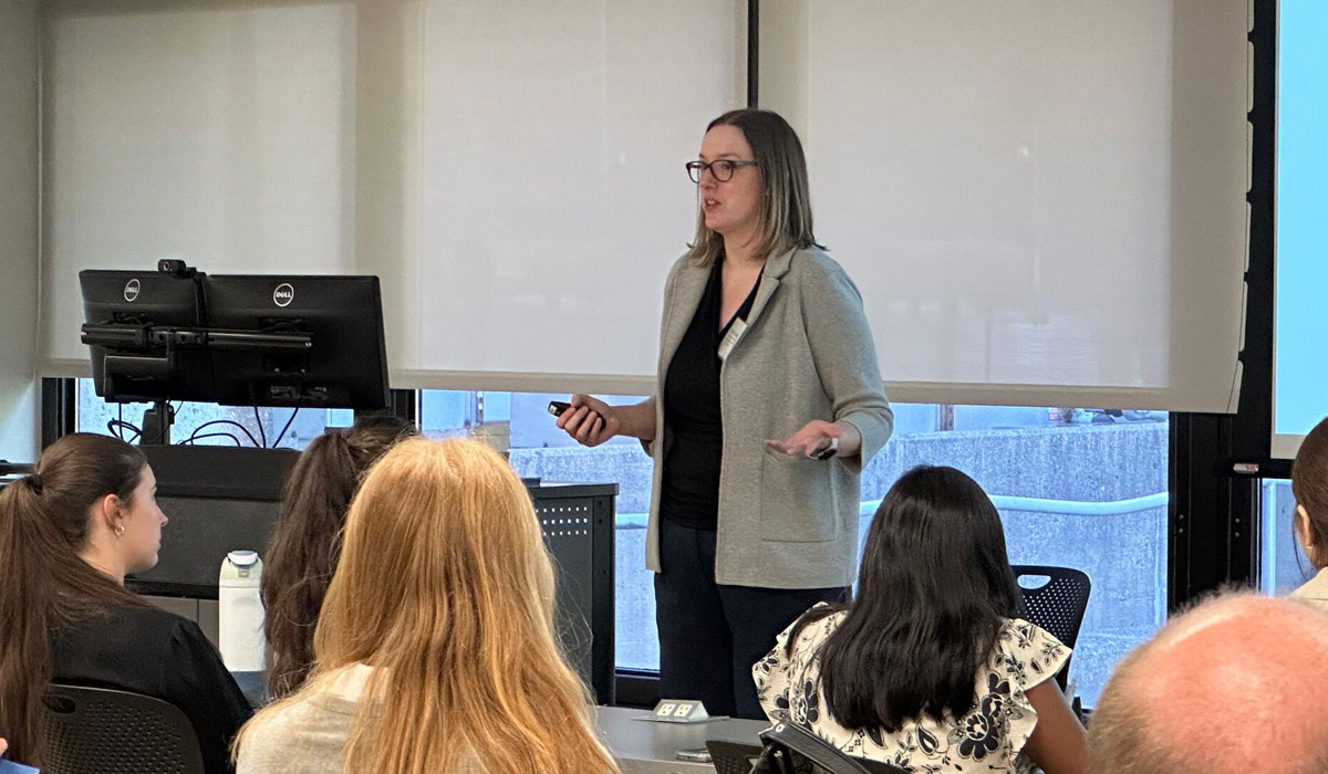 Danielle Dougherty, Director of Admissions for COMLS Programs, presents to a classroom of prospective students at OMED 2025.